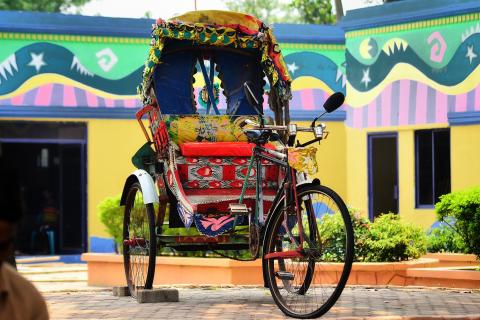Rickshaw. The Bengali for "rickshaw" is "রিকশা".