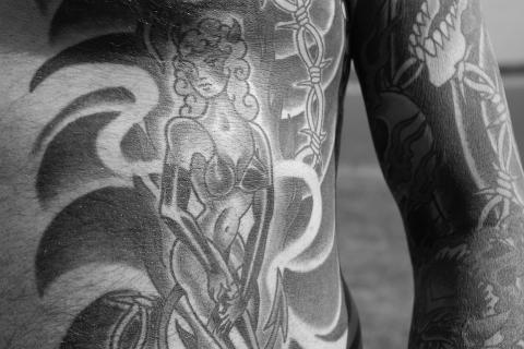 Tattoo. The Dutch for "tattoo" is "tatoeage".