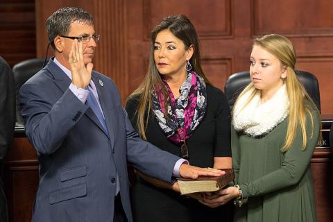 To swear. The Dutch for "to swear" is "vloeken".