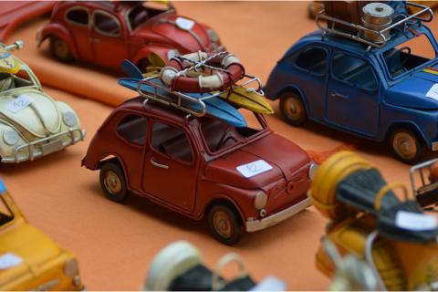 Some toy cars. The French for "some toy cars" is "des voitures miniatures".