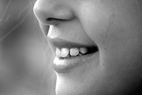 Smiling; cheerful (feminine). The French for "smiling; cheerful (feminine)" is "souriante".