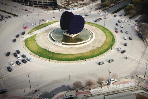 A roundabout; a traffic circle. The French for "a roundabout; a traffic circle" is "un rond-point".