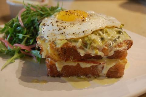 Toasted cheese and ham sandwich with a fried egg on top. The French for "toasted cheese and ham sandwich with a fried egg on top" is "croque-madame".