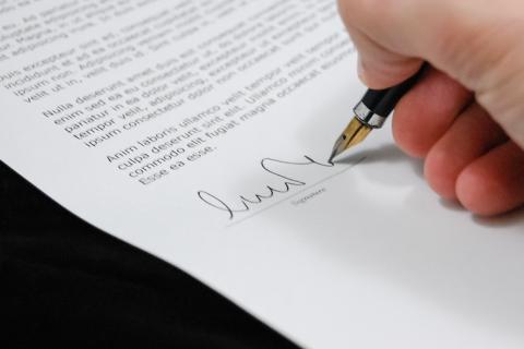 To sign. The German for "to sign" is "unterschreiben".