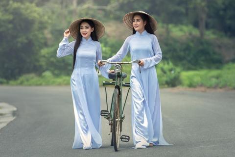 Two women and a bicycle. The Thai for "two women and a bicycle" is "ผู้หญิงสองคนและจักรยาน".