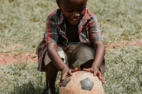 A boy and a ball. The Thai for "a boy and a ball" is "เด็กผู้ชายและลูกบอล".