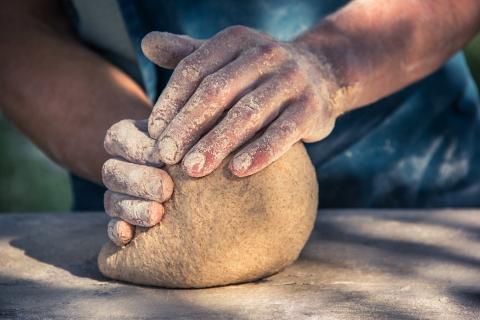 To mold; to knead. The Thai for "to mold; to knead" is "ปั้น".