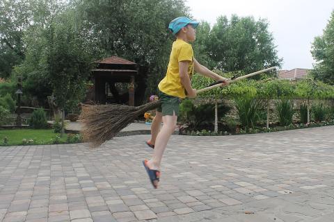 A boy and a broom. The Thai for "a boy and a broom" is "เด็กผู้ชายและไม้กวาด".