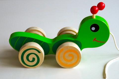 A wooden toy. The Thai for "a wooden toy" is "ของเล่นไม้".