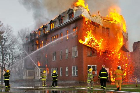 A building on fire. The Thai for "a building on fire" is "ไฟไหม้อาคาร".