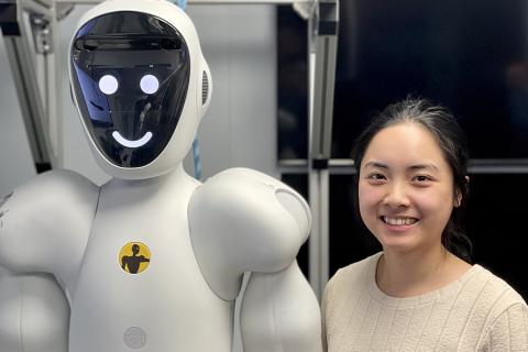 A woman with a robot. The Thai for "a woman with a robot" is "ผู้หญิงกับหุ่นยนต์".