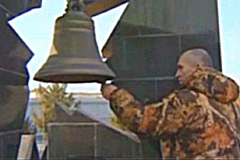 A man ringing a bell. The Thai for "a man ringing a bell" is "ผู้ชายตีระฆัง".