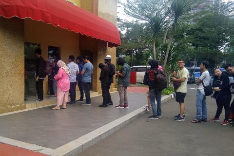 People queuing in front of an ATM. The Thai for "people queuing in front of an ATM" is "คนเข้าคิวหน้าเอทีเอ็ม".