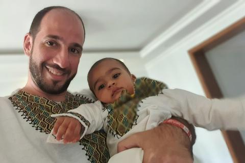 A man holding his son. The Thai for "a man holding his son" is "ผู้ชายอุ้มลูกชายของเขา". A man holding his son. The Thai for "a man holding his son" is "ผู้ชายอุ้มลูกชายของเขา".