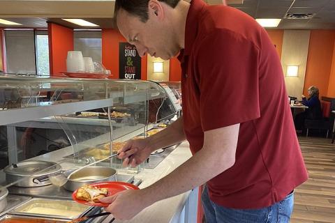 A man at a restaurant buffet. The Thai for "a man at a restaurant buffet" is "ผู้ชายในร้านอาหารบุฟเฟ่ต์". A man at a restaurant buffet. The Thai for "a man at a restaurant buffet" is "ผู้ชายในร้านอาหารบุฟเฟ่ต์".