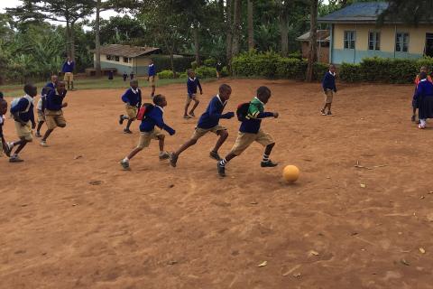 Primary school students playing football. The Thai for "primary school students playing football" is "นักเรียนประถมเล่นฟุตบอล".