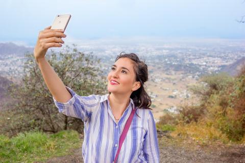 To take a selfie. The Thai for "to take a selfie" is "ถ่ายเซลฟี่".