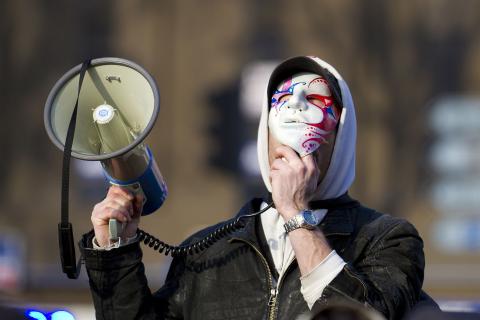 A protester with his megaphone. The Thai for "a protester with his megaphone" is "ผู้ประท้วงกับโทรโข่งของเขา".