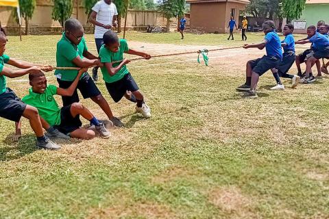 Students competing in a tug of war. The Thai for "students competing in a tug of war" is "นักเรียนแข่งชักกะเย่อ".