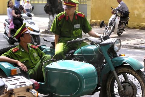 Two policemen on a motorbike with sidecar. The Thai for "two policemen on a motorbike with sidecar" is "ตำรวจสองนายบนมอร์เตอร์ไซค์พ่วงข้าง".