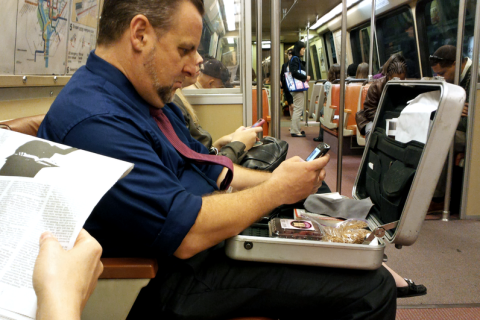 A man opening his briefcase on the metro. The Thai for "a man opening his briefcase on the metro" is "ผู้ชายเปิดกระเป๋าเอกสารของเขาบนรถไฟฟ้า". A man opening his briefcase on the metro. The Thai for "a man opening his briefcase on the metro" is "ผู้ชายเปิดกระเป๋าเอกสารของเขาบนรถไฟฟ้า".