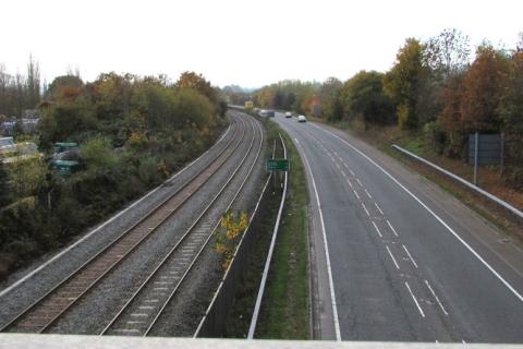 A parallel road and railway. The Thai for "a parallel road and railway" is "ถนนขนานกับรางรถไฟ".