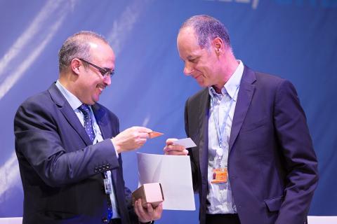 Two men exchanging business cards. The Thai for "two men exchanging business cards" is "ผู้ชายสองคนแลกนามบัตร".