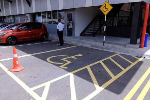 Accessible parking. The Thai for "accessible parking" is "ที่จอดรถคนพิการ".